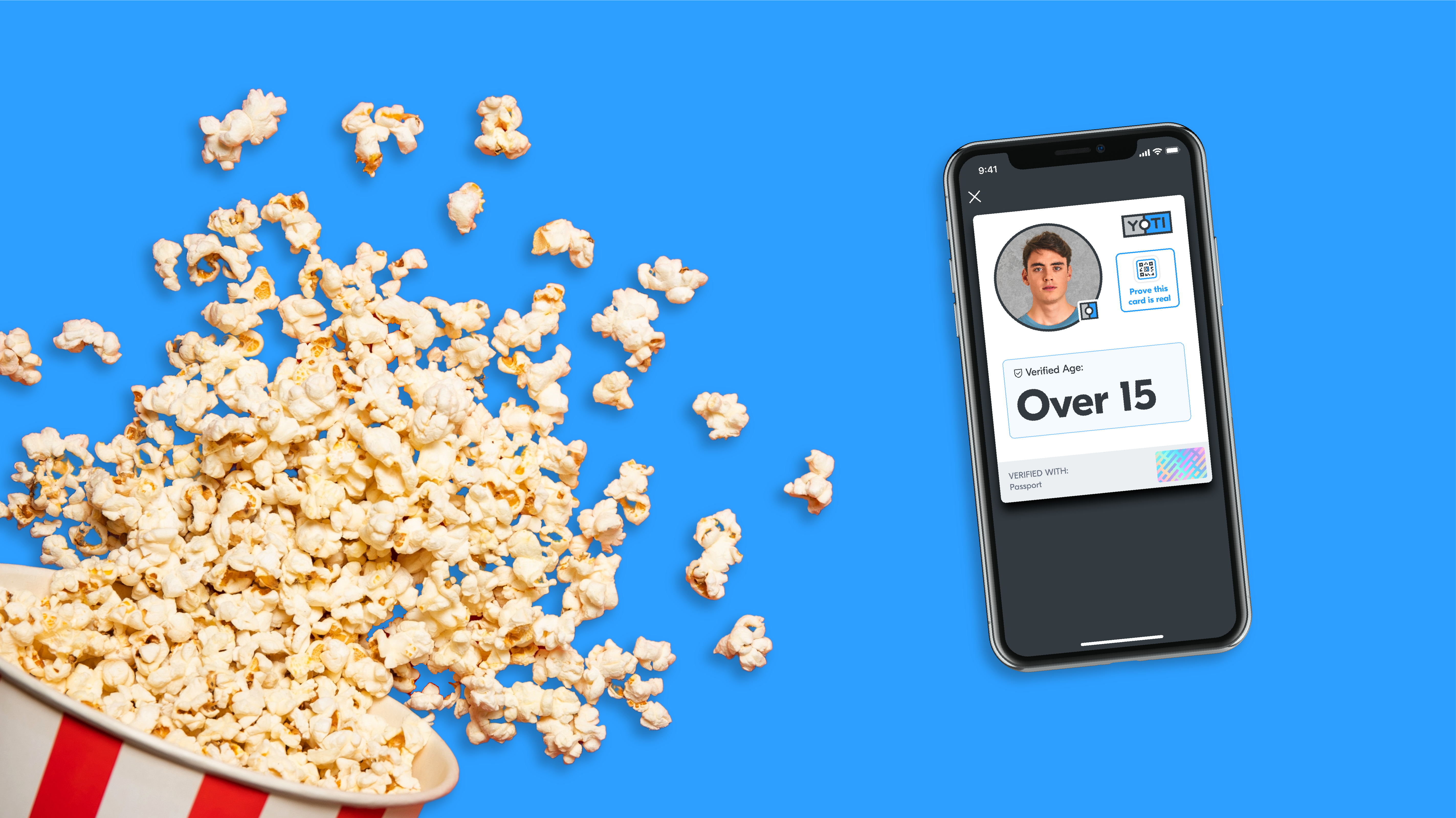 a bucket of spilt pop corn and a smart phone with a screen showing the app and the words 